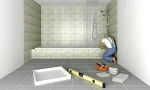 Un obrero instala una bañera de obra. Herramientas y toallas esperan en el suelo.