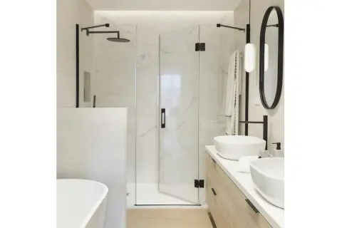 Modern bathroom with a glass shower enclosure, a built-in shower wall, and a freestanding bathtub.