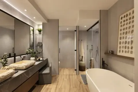 Elegante baño moderno con lavabos de piedra natural, bañera exenta y ducha acristalada. La decoración baños combina texturas y tonos neutros.