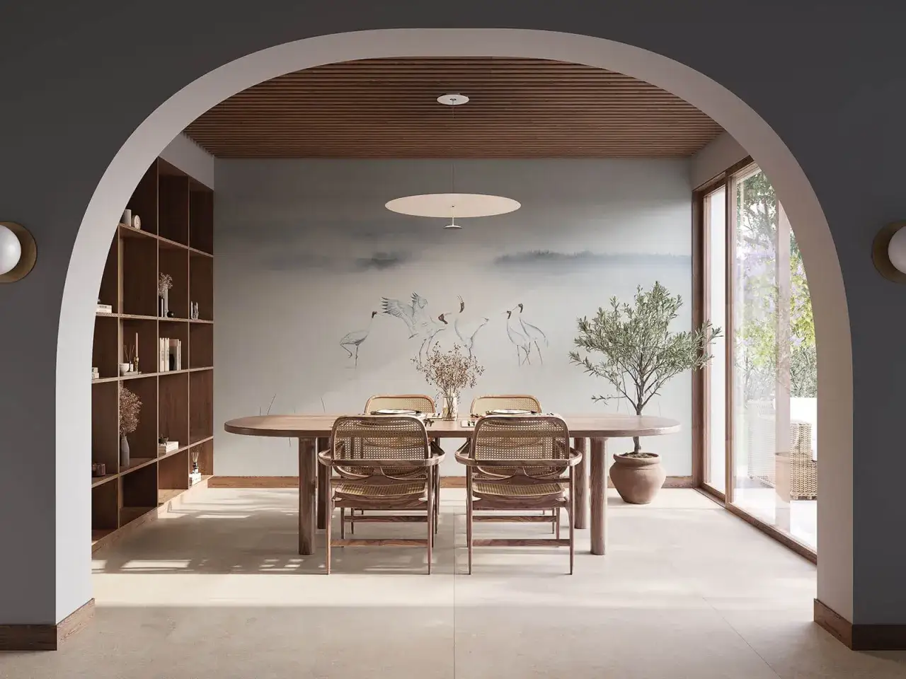 Comedor con mural de grullas, estantería de madera y mesa ovalada. Un espacio que evoca la serenidad del feng shui.
